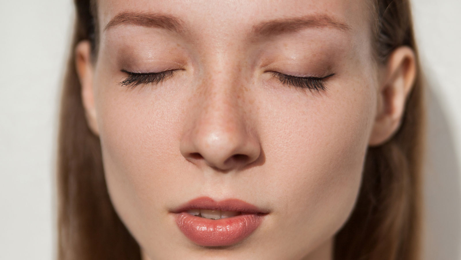 Woman up close of face with eyes closed